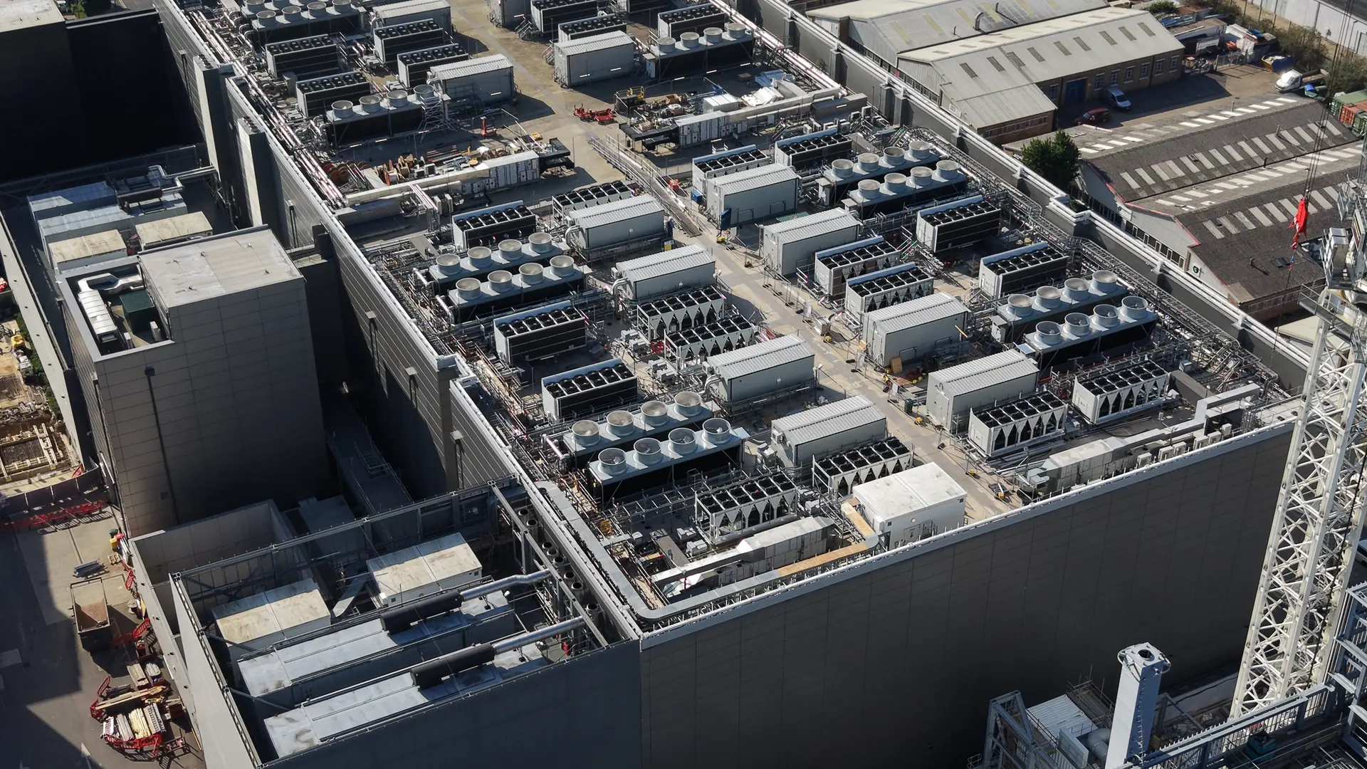 Aerial view of a data centre roof lined with chillers and dry coolers