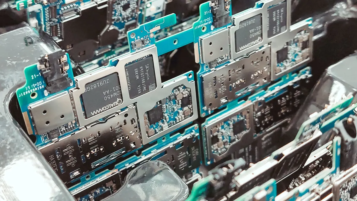 Rows of circuit boards standing upright in clear trays