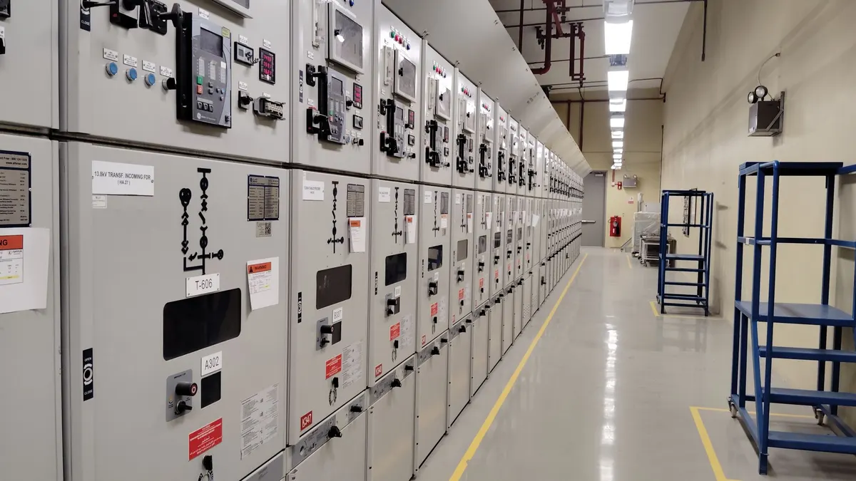 Long row of medium voltage switchgear panels in an electrical room